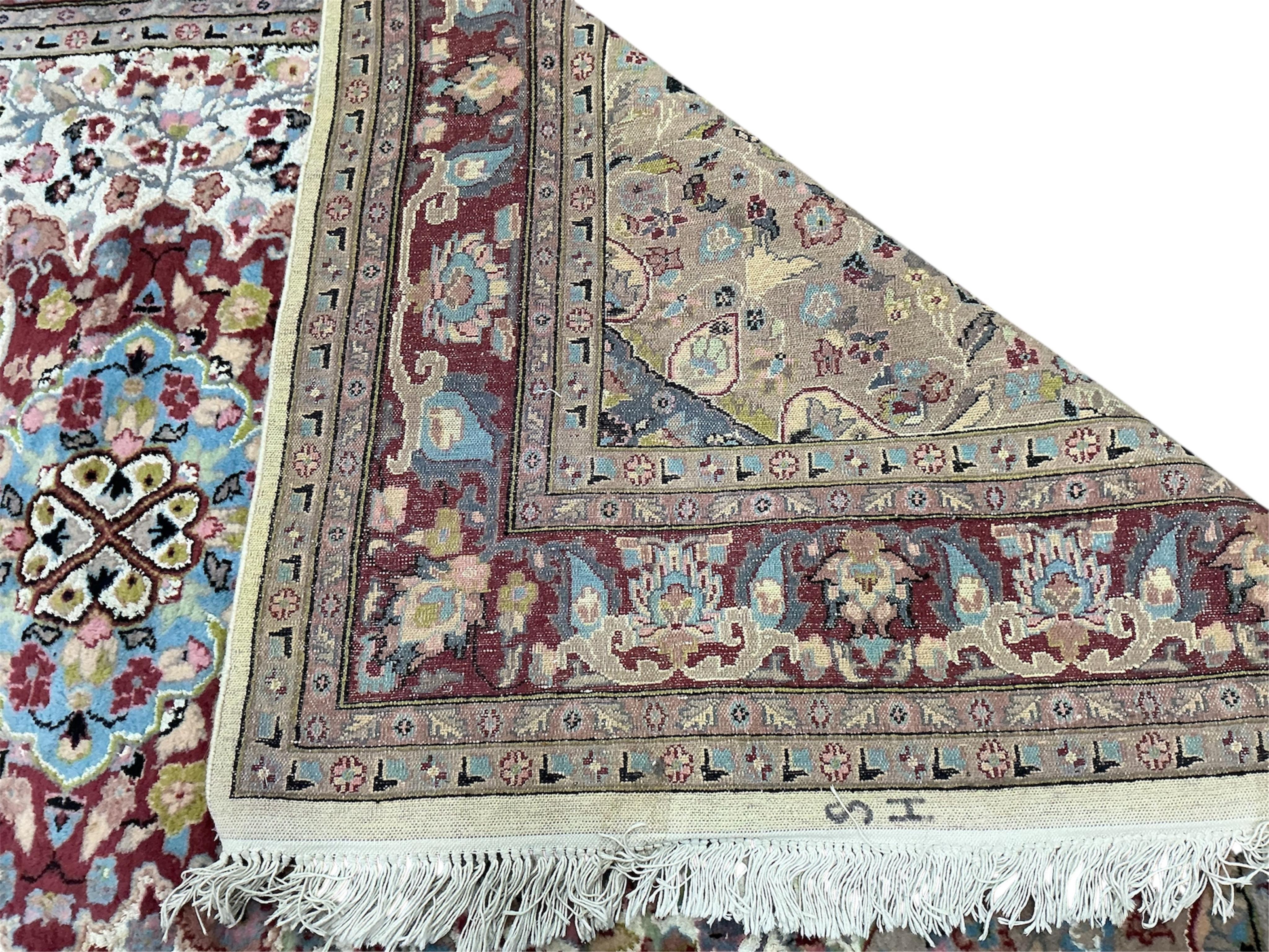 A Pakistan ivory ground part silk medallion carpet, 283 x 192cm